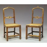A pair of Gothic Revival oak side chairs, the arched backrest having central splat with pierced