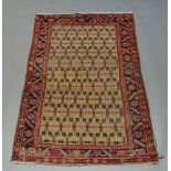 A Northwest Persian rug with oatmeal coloured field and indigo main border, 186cm x 127cm200