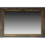 A carved gilt wood mirror, in the Louis VI taste, second half 20th Century, of rectangular form with