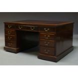 An Edwardian mahogany partner's desk, the rectangular top inset with burgundy leather writing