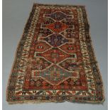 A Kazak rug, with five conjoined medallions, and ivory main border, 236cm x 113cm and two other rugs