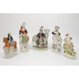 A group of five Staffordshire figures, mid/late 19th century, to comprise a highland man with a