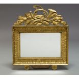 A gilt gesso rectangular wall mirror, late 19th Century, the pierced cresting with French horn, harp