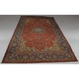 WITHDRAWN. A Tabriz carpet, mid 20th Century, the pole medallion in red floral foliate field with