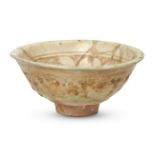 An Iranian bowl, covered with a greenish white glaze, decorated with a band of geometrical