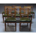 A set of nine late Victorian mahogany dining chairs, with slatted backs above green leather