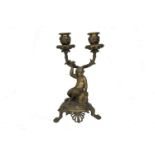 A French bronze twin branch candelabra, late 19th/early 20th century, modelled with a figure of a