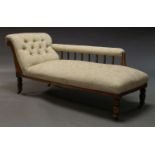 An Edwardian chaise longue, with scrolling end, the armrest with baluster turned supports, above