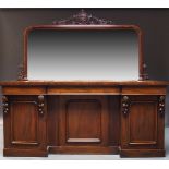 A Victorian mahogany inverse breakfront sideboard, with raised mirrored back centred by pierced