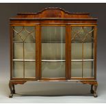 An Edwardian mahogany triple display cabinet, the top with raised shaped back, above central