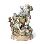 A Continental Meissen style porcelain figure group, late 19th century, set in a natural landscape, a