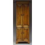 A Victorian oak cabinet, the moulded cornice above two panelled cupboard doors, each enclosing three