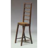 An unusual late Victorian mahogany child's deportment chair, with high spindle back, on square