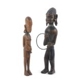 Two African hardwood figures, 20th century, to comprise a male figure with pendulous ears enriched
