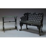 A Victorian black painted cast iron garden bench, with scrolling top rail above pierced backrest and