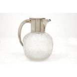 A German silver mounted cut glass dimpled wine jug, J.Netter & Cie., the globular, dimpled glass