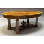 A mahogany and inlaid extending dining table, 20th Century, the oval top centred by inlaid patera,