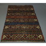 A West Persian Kilim, early to mid 20th of polychromatic stripe design, 260cm x 146cm together