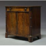 A George III mahogany serpentine fronted cupboard, with single frieze drawer above two cupboard