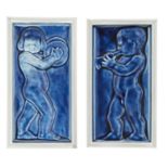 Two blue figurative tile panels 20th Century Each cast with a putti, one playing a trumpet, the