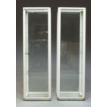 A pair of white painted wood and glass display cabinets, c.1960's/70's, each with three shelves,