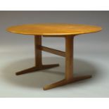 A circular teak dining table, c.1970, the top with one drop leaf raised on square legs to sledge