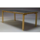 Alvar Aalto, a model 83 dining table for Artek, with black Formica top on, laminated plywood legs,