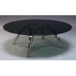 A modern chrome coffee table, c.1980, with circular tinted glass top, on curved chrome supports,