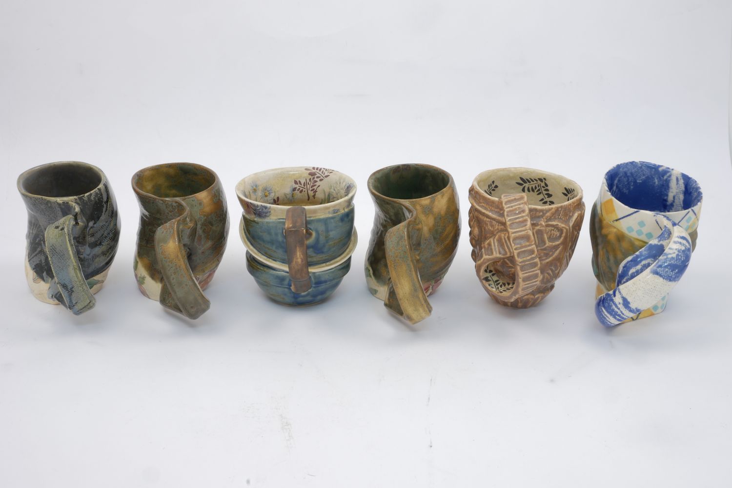 Carol McNicoll (1943-), six assorted mugs c.1990, each signed to base Six assorted slipcast mugs