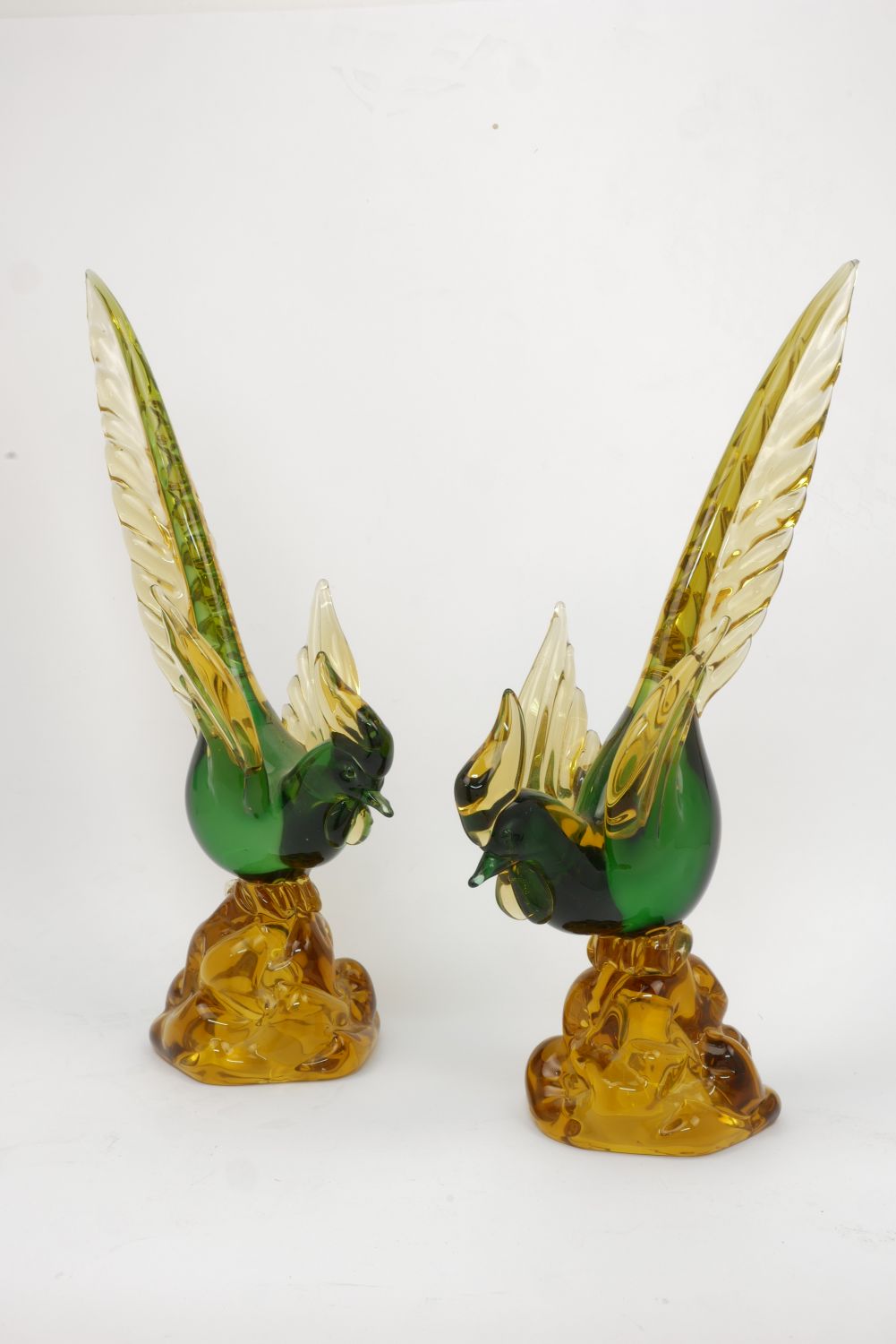 A pair of Italian glass birds, 20th century, the bird with a green body yellow wings and a long