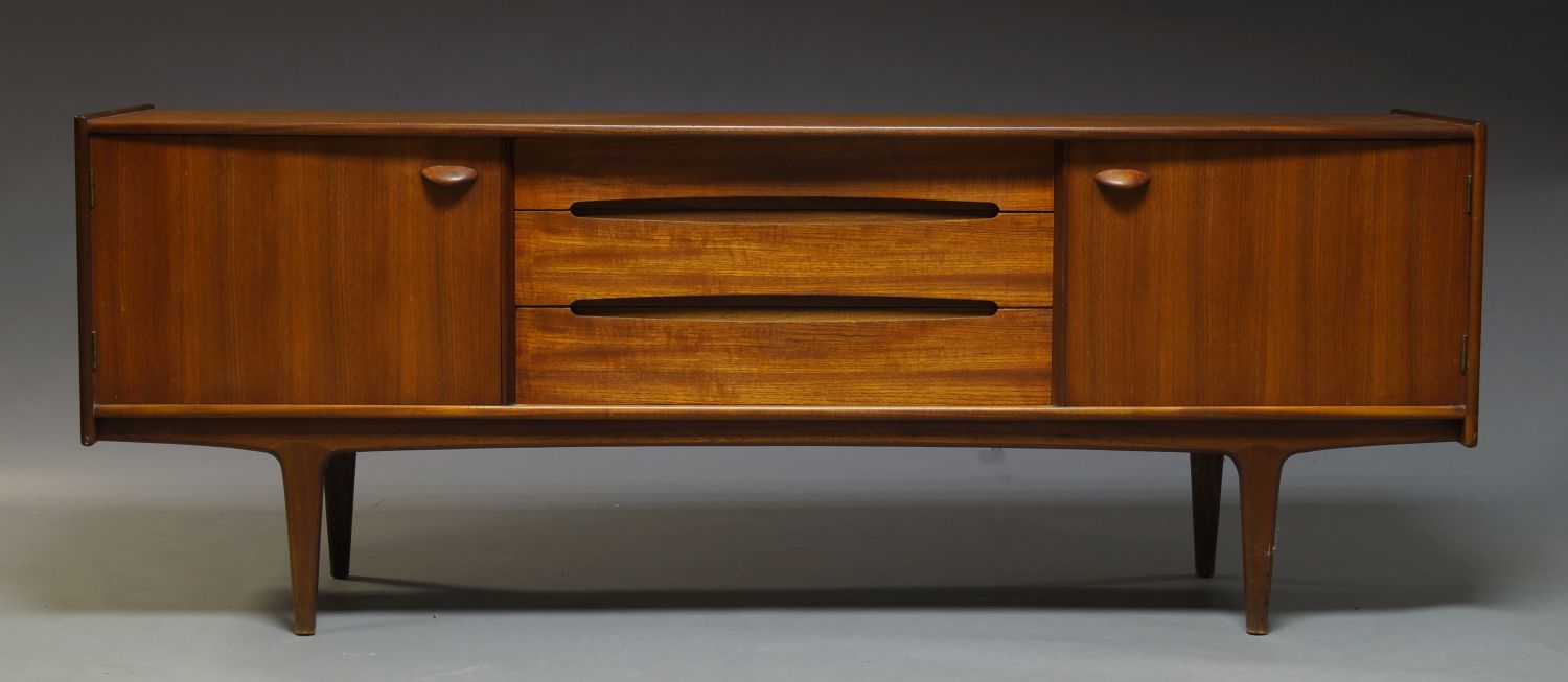 A teak sideboard by Younger, c.1960, the rectangular top above three drawers, flanked by two