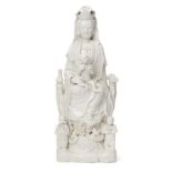 A large Chinese Dehua porcelain figure of Guanyin, 17th/18th century, Guanyin modelled seated on a