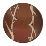 Shoji Hamada, Japanese 1894-1978, a stoneware dish with tenmoku glaze, diameter 27.5cm Provenance: