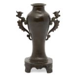 A Japanese bronze twin-handled vase, Meiji period, with ho-o bird handles to body, on footed base,
