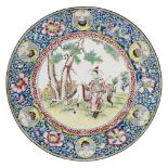 A Chinese Canton enamel plate, late 19th century, painted to the central reserve with a lady and a
