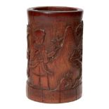 A Chinese bamboo brush pot, late 19th century, carved with an immortal and attendant in a landscape,