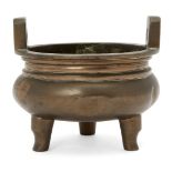 A Chinese bronze circular tripod censer, 18th century, cast four-character mark to base, 12cm