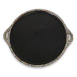 A Japanese lacquered wood circular tray, early 20th century, the raised rim inlaid with mother of