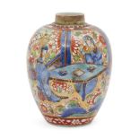 A Chinese porcelain 'clobbered' small ovoid jar, Kangxi period, painted in underglaze blue with