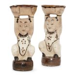 A pair of Chinese pottery Cizhou figural incense holders, Ming dynasty, moulded as boys seated on