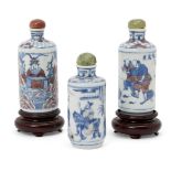 Three Chinese porcelain cylindrical snuff bottles, 19th century, each painted in underglaze blue and