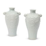 A pair of Chinese porcelain archaistic baluster vases, late Qing dynasty, the shoulder moulded