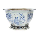 A Chinese porcelain hexagonal jardinière, 18th century, painted in underglaze blue with panels of
