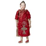 A Chinese composite female doll, early 20th century, with painted features and wearing a red silk