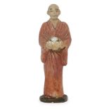 A Japanese figure of a man holding a brimming bowl, Meiji period, painted composite, 13cm highPlease