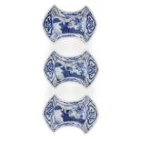 Three Japanese porcelain ingot shaped dishes, Meiji period, painted in underglaze blue with