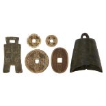 A Chinese bronze miniature bell, Tang dynasty, 7.5cm long, four Chinese coins, and a brass plaque (