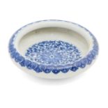 A Chinese porcelain circular brushwasher, Republic period, painted in underglaze blue with leafy