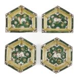 Four Chinese biscuit porcelain sancai hors d'oeurves dishes, Kangxi period, each painted with a