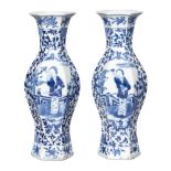 A pair of Chinese porcelain hexagonal vases, 19th century, painted in underglaze blue with panels of